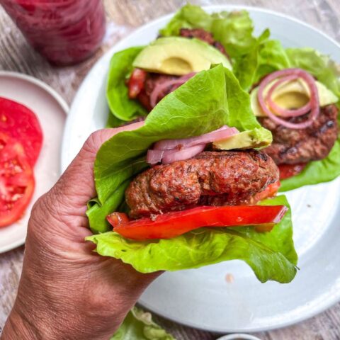 bison burger in hand