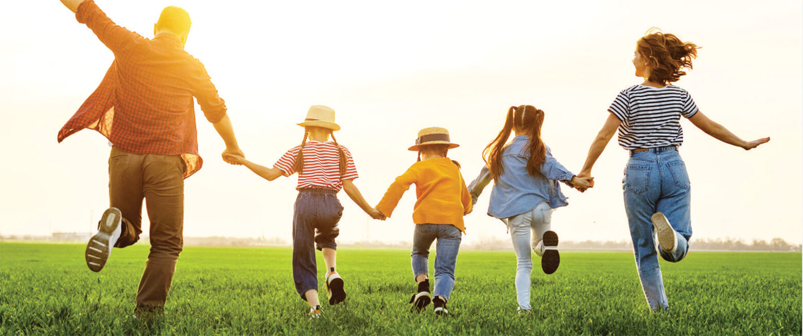 Family Running Together in a Field