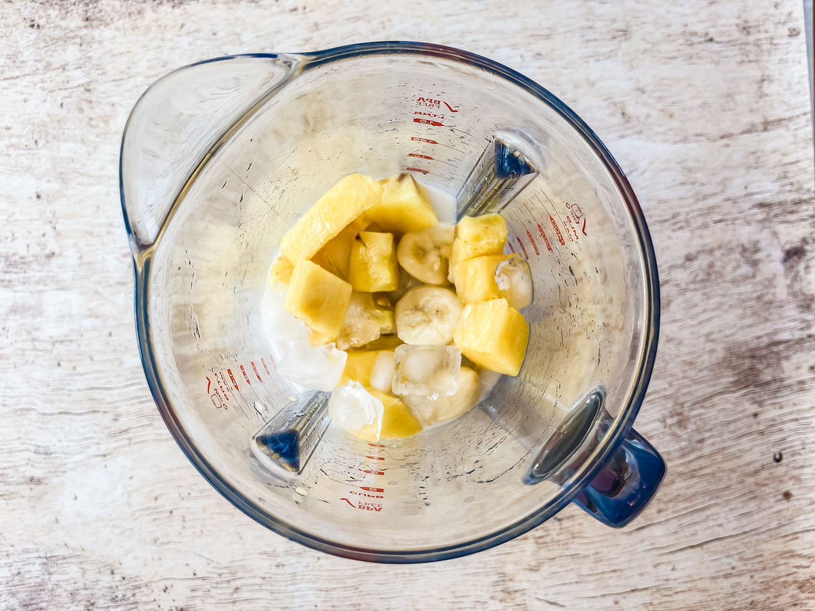 fruit in blender for tropical smoothie bowl