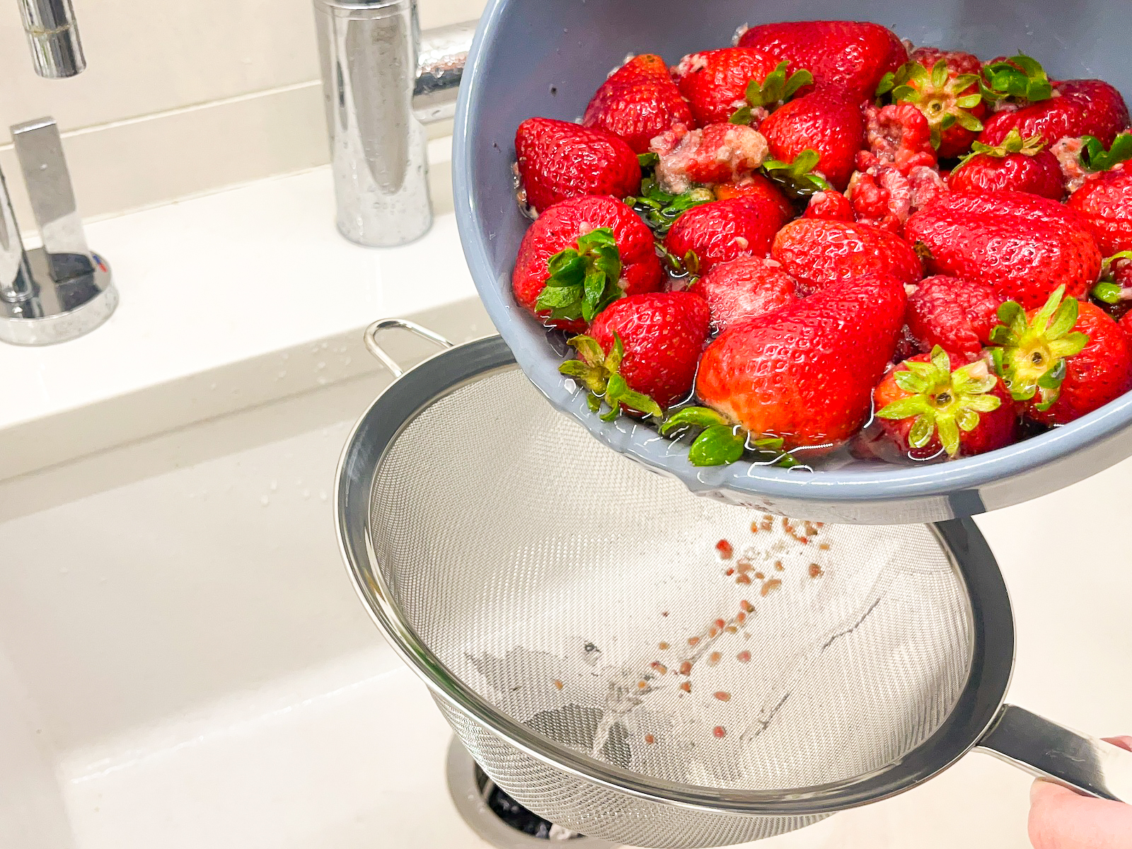 Berries being strained from the produce wash.