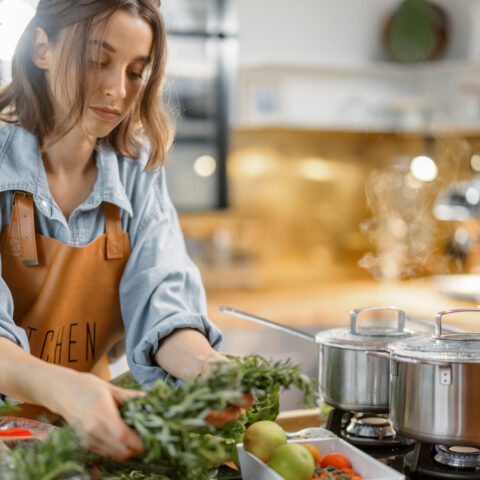 A woman preps a vegetarian meal in the kitchen