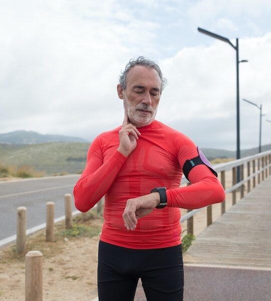 man checking his pulse after running