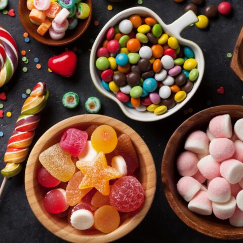 colorful but unhealthy Halloween candies in dishes