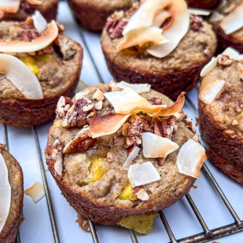 Pineapple coconut muffins on a cooling rack