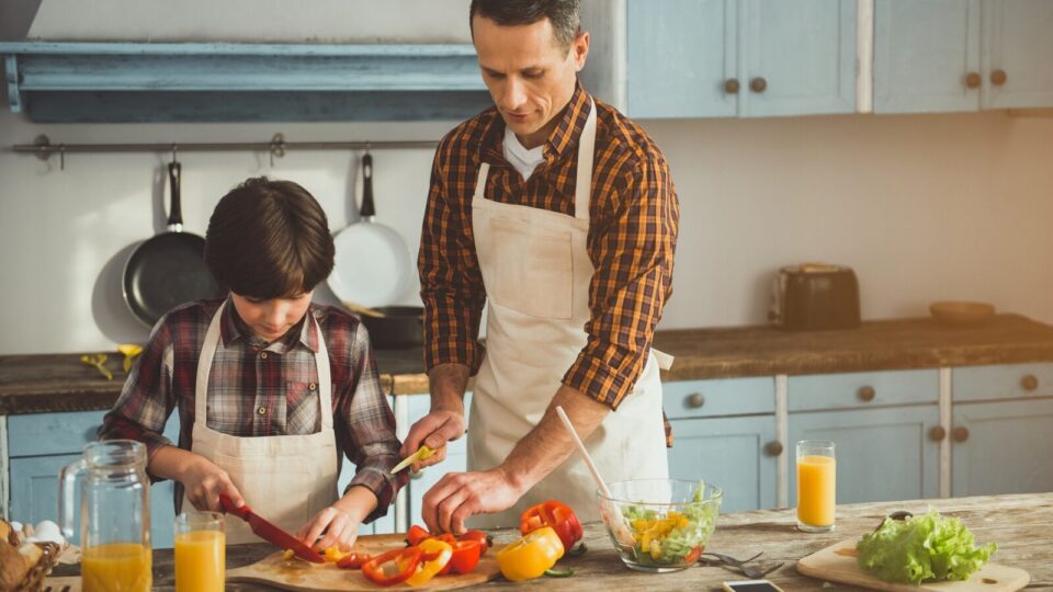 Father and son prepping food in the kitchen.