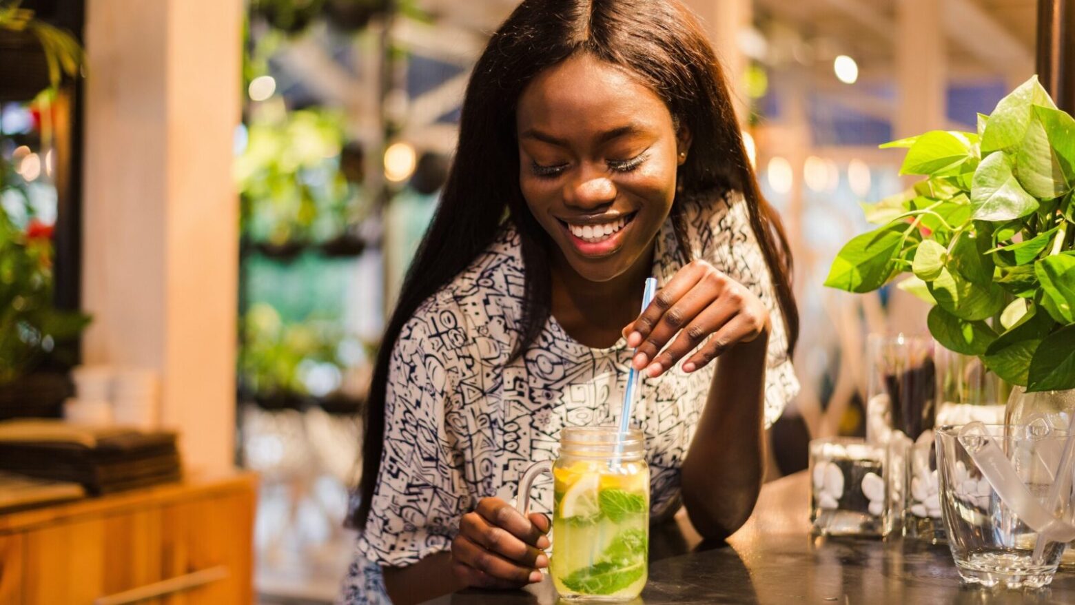 Woman enjoying a lemon and mint leaf water.