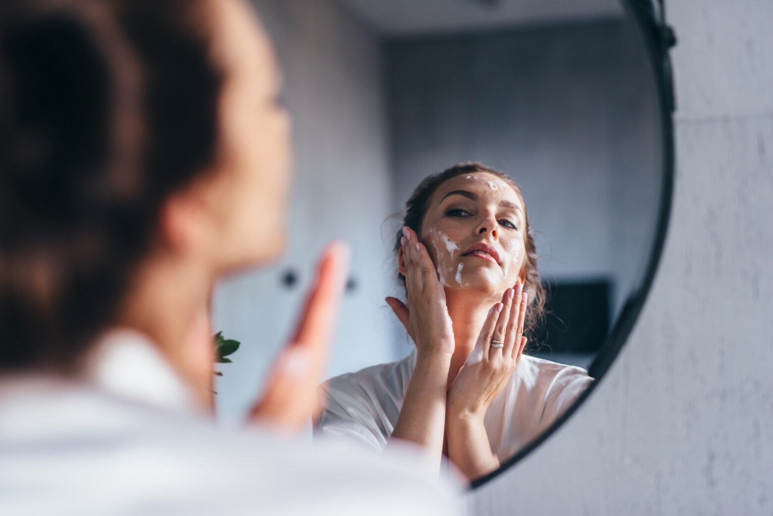 women washing her face in the sink