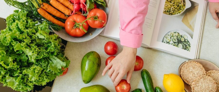 women cooking dinner with a cookbook