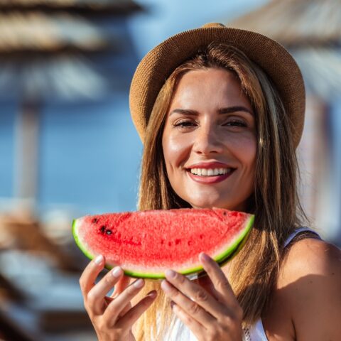 women holding a watermelon and smiling